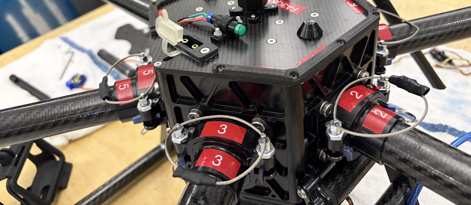 The hexacopter core with red cam levers, carbon plates and tube arms
