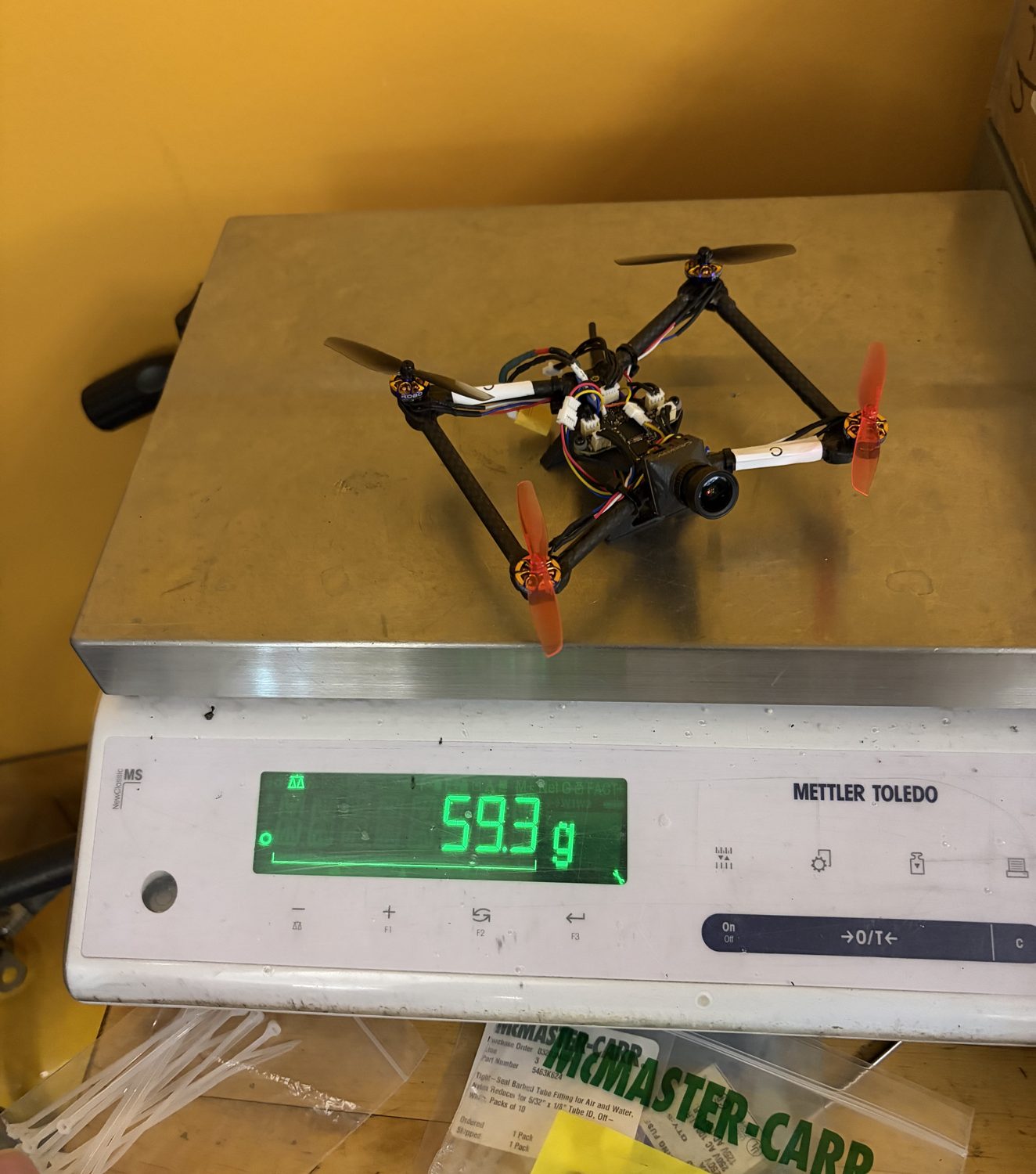 The tiny whoop on a scale reading 59.3 grams